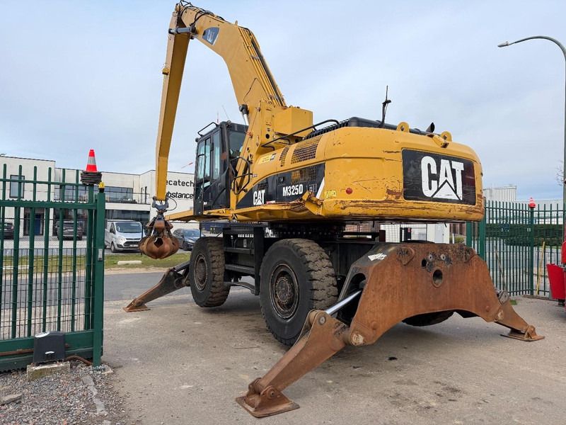 2011 Caterpillar M325D material handler, rear three-quarter view