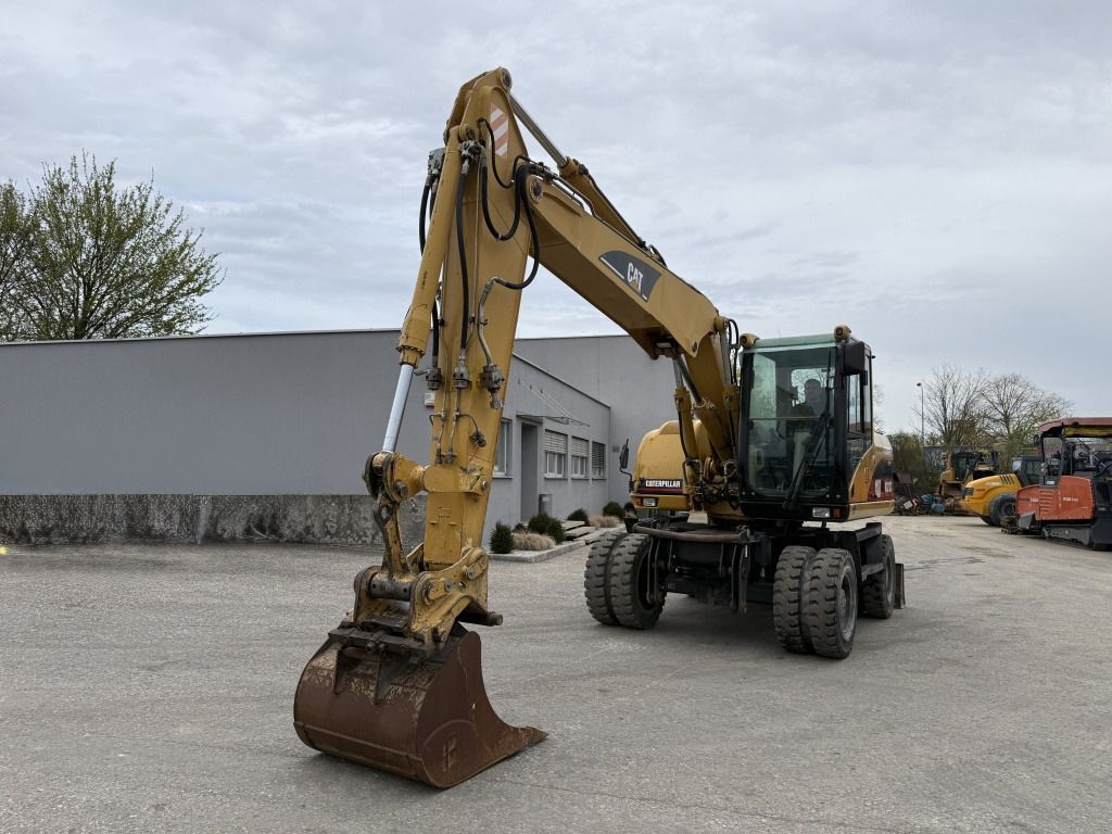 2006 Caterpillar M313C wheel excavator, front three-quarter view 2006 Caterpillar M313C wheel excavator, front three-quarter view