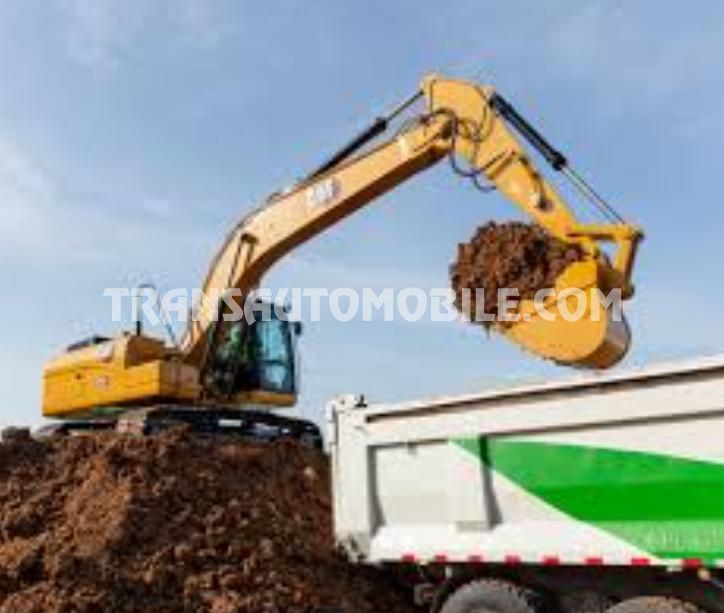 Caterpillar 320GC crawler excavator loading a truck Caterpillar 320GC crawler excavator loading a truck