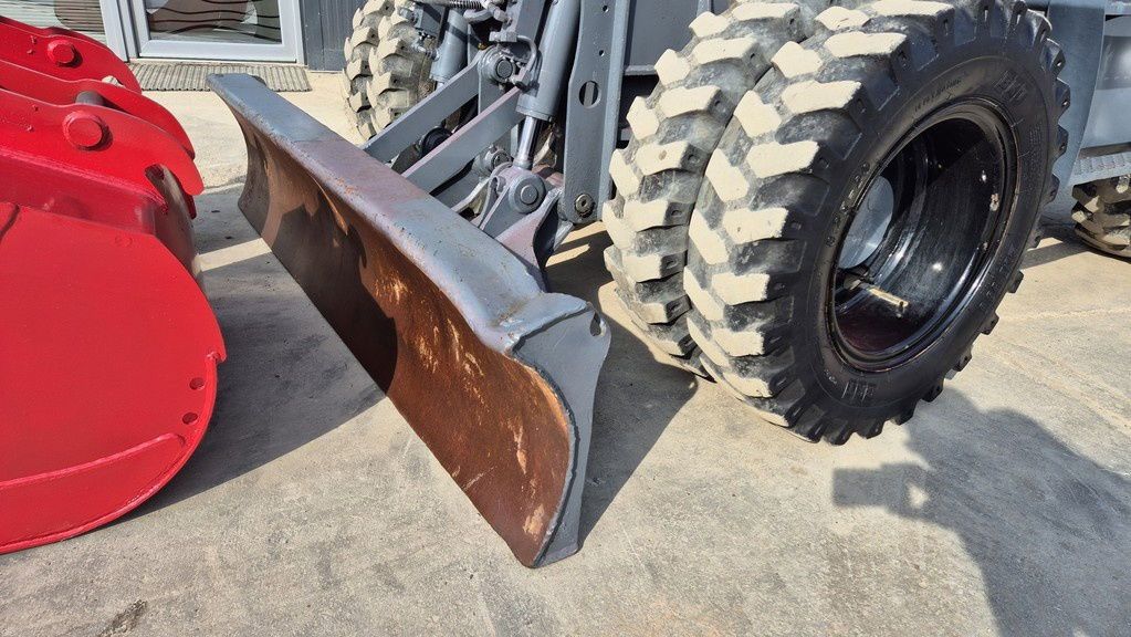2021 Takeuchi TB295W wheel excavator dozer blade and tire detail