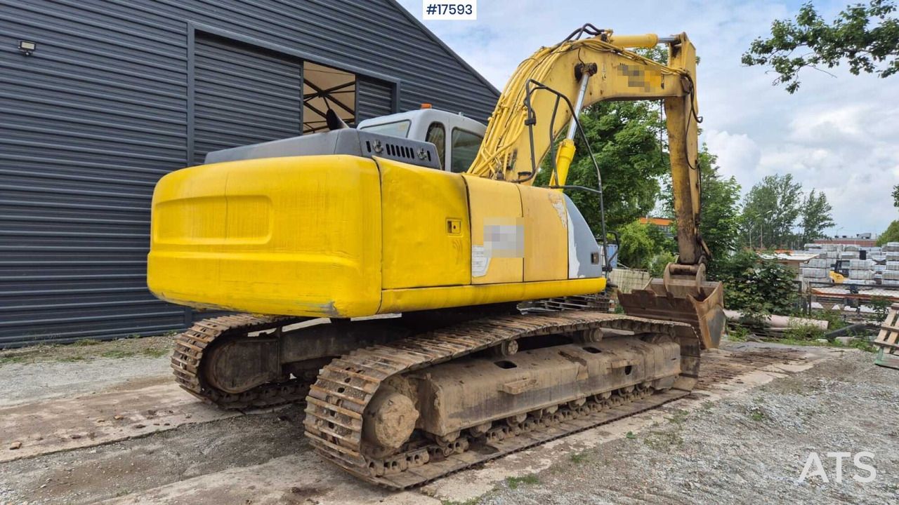 2005 New Holland E215 crawler excavator rear three-quarter view 2005 New Holland E215 crawler excavator rear three-quarter view