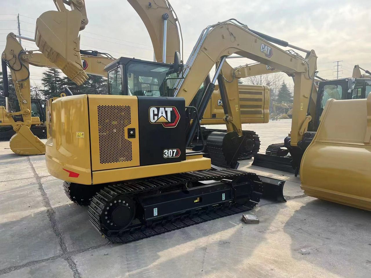 2026 Caterpillar 307 mini excavator, rear three-quarter view 2026 Caterpillar 307 mini excavator, rear three-quarter view