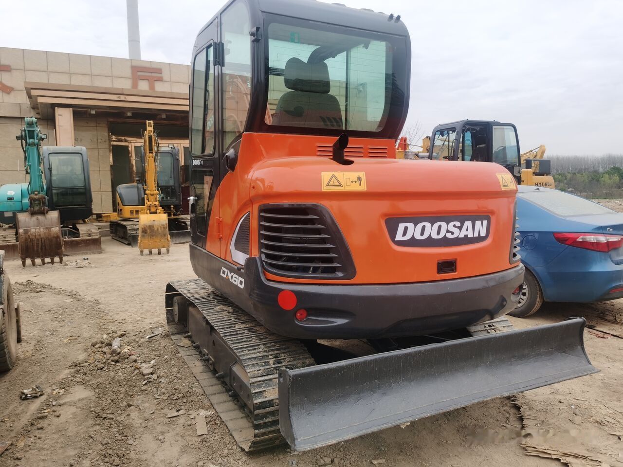 Doosan DX60 crawler excavator, rear three-quarter view Doosan DX60 crawler excavator, rear three-quarter view