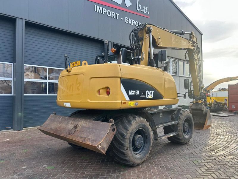 2014 Caterpillar M315D wheel excavator, rear three-quarter view