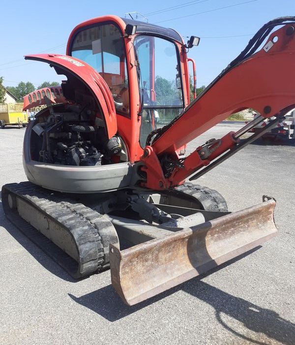 JCB 5 T235 mini excavator, rear three-quarter view with engine compartment open JCB 5 T235 mini excavator, rear three-quarter view with engine compartment open