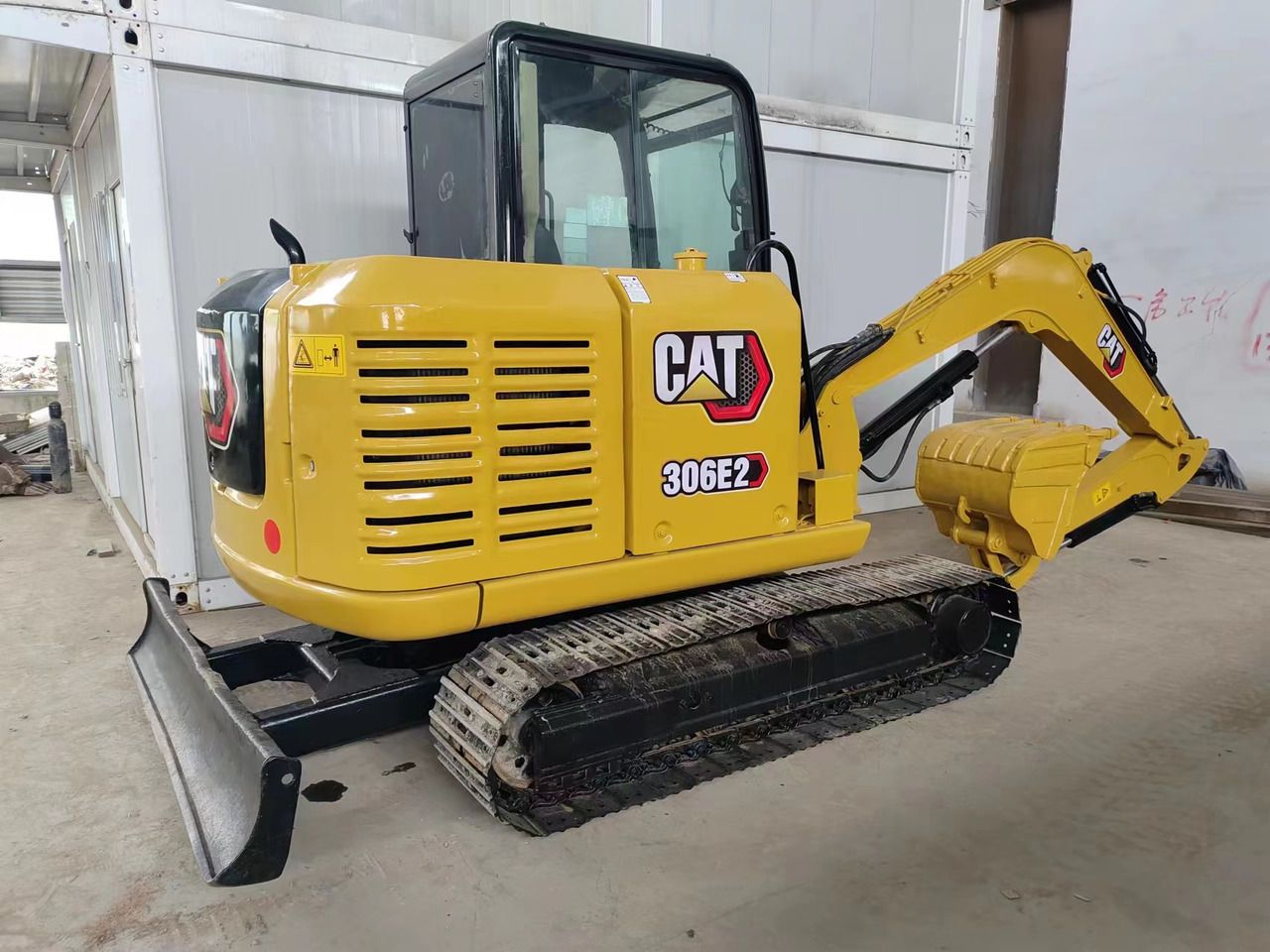 2022 Caterpillar 306E2 mini excavator, rear three-quarter view 2022 Caterpillar 306E2 mini excavator, rear three-quarter view