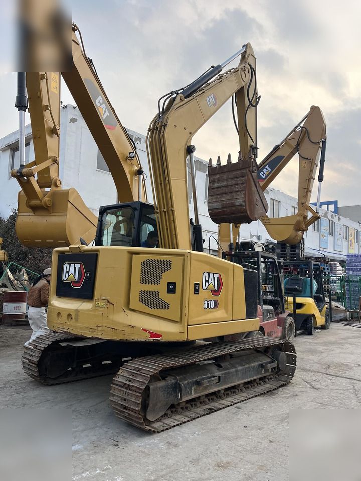 2019 Caterpillar 310 crawler excavator, rear three-quarter view
