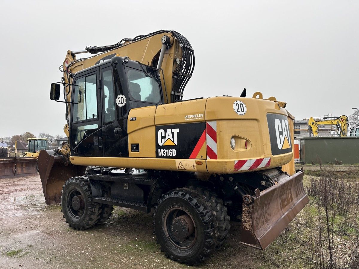 2013 Caterpillar M316D wheel excavator, rear three-quarter view 2013 Caterpillar M316D wheel excavator, rear three-quarter view