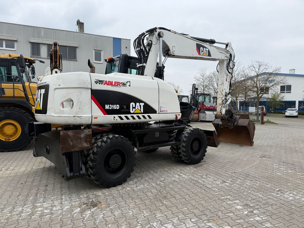 2010 Caterpillar M316D wheel excavator, rear three-quarter view
