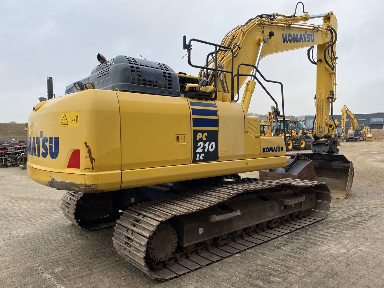 2019 Komatsu PC210LC-11 crawler excavator, rear three-quarter view 2019 Komatsu PC210LC-11 crawler excavator, rear three-quarter view
