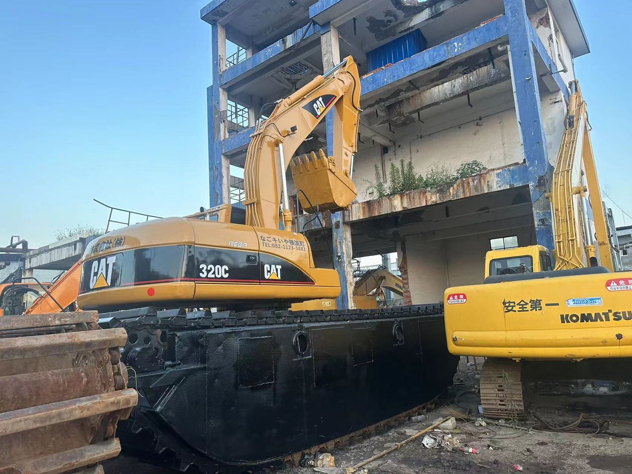 2018 Caterpillar 320C amphibious excavator, rear three-quarter view