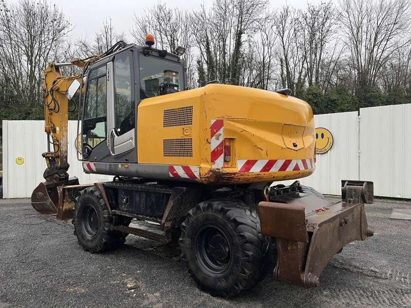 2010 Hitachi ZX140W-3 wheel excavator, rear three-quarter view 2010 Hitachi ZX140W-3 wheel excavator, rear three-quarter view