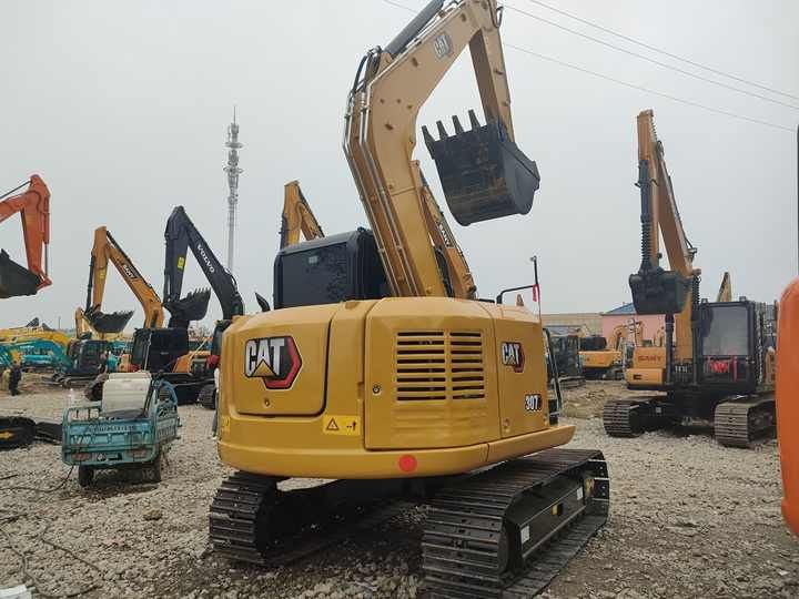 2022 Caterpillar 307E mini excavator, rear three-quarter view 2022 Caterpillar 307E mini excavator, rear three-quarter view