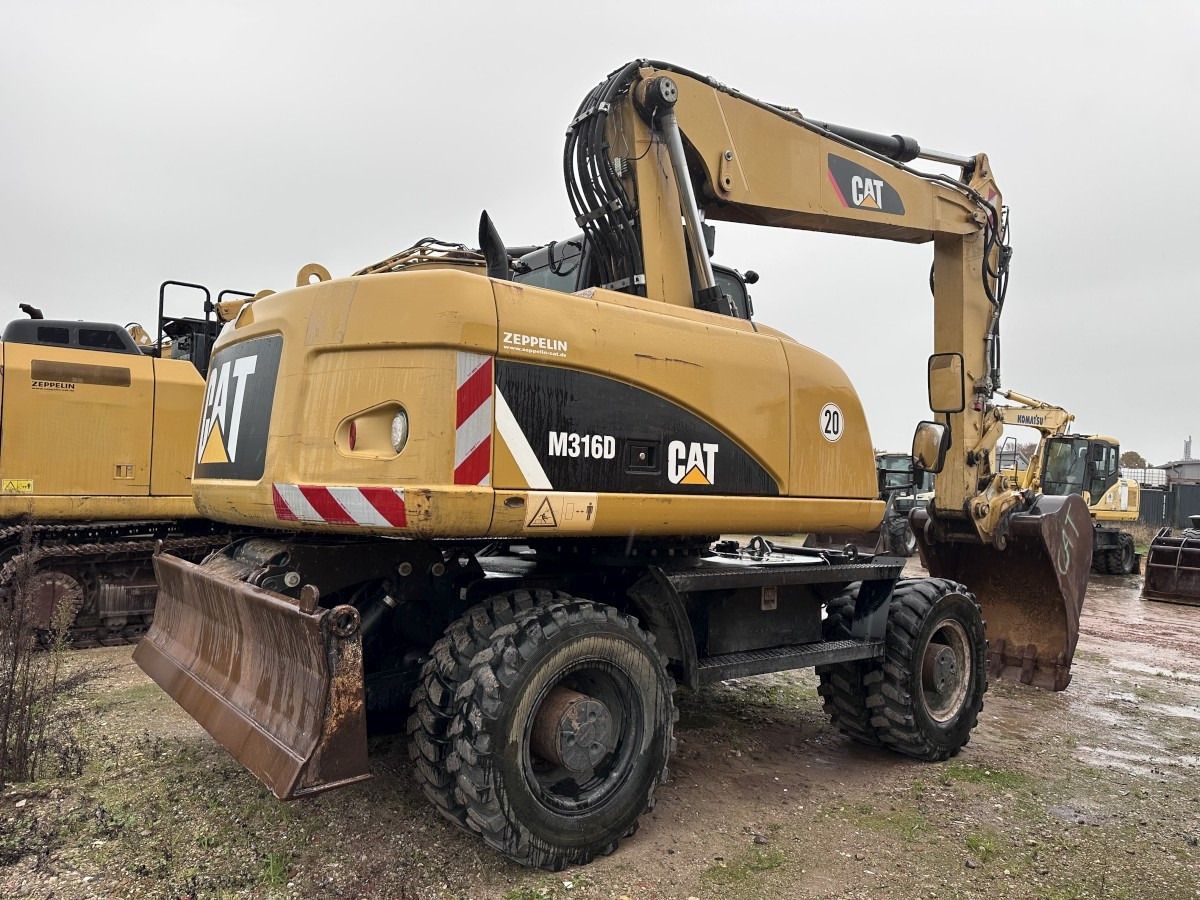 2013 Caterpillar M316D wheel excavator, rear three-quarter view 2013 Caterpillar M316D wheel excavator, rear three-quarter view
