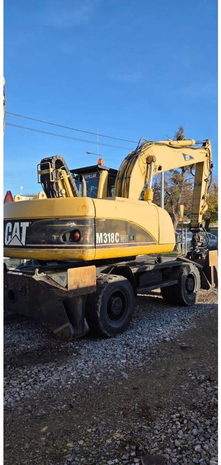 2006 Caterpillar M318CMH wheel excavator, rear three-quarter view