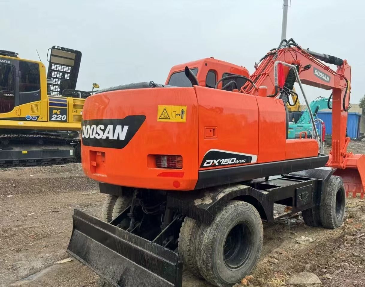 2022 Doosan DX150W-9C wheel excavator, rear three-quarter view 2022 Doosan DX150W-9C wheel excavator, rear three-quarter view