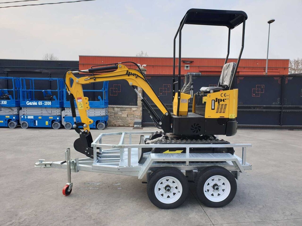 JPC HT-12 mini excavator on a trailer, side view JPC HT-12 mini excavator on a trailer, side view