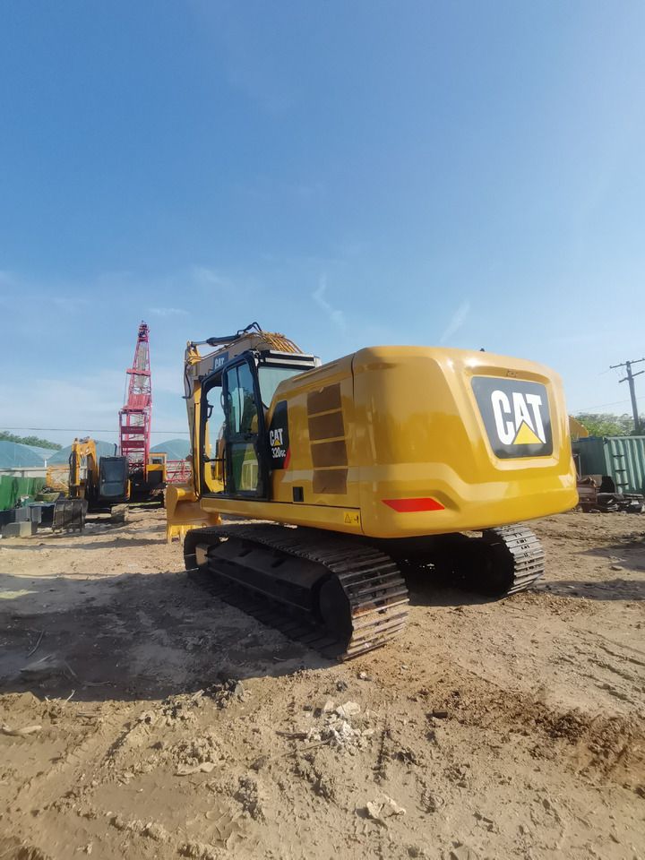 2022 Caterpillar 320GC crawler excavator, rear three-quarter view 2022 Caterpillar 320GC crawler excavator, rear three-quarter view
