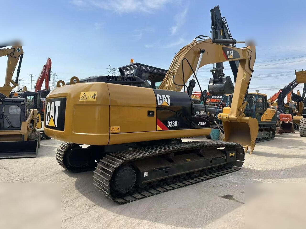 2009 Caterpillar 323DL crawler excavator, rear three-quarter view