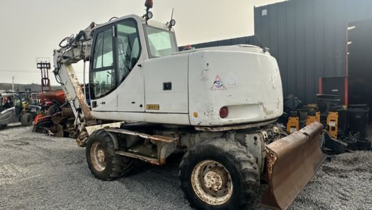 2005 CASE WX165 wheel excavator, rear three-quarter view 2005 CASE WX165 wheel excavator, rear three-quarter view