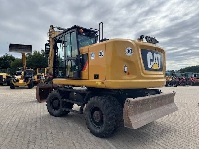 2019 Caterpillar M318F wheel excavator, rear three-quarter view 2019 Caterpillar M318F wheel excavator, rear three-quarter view