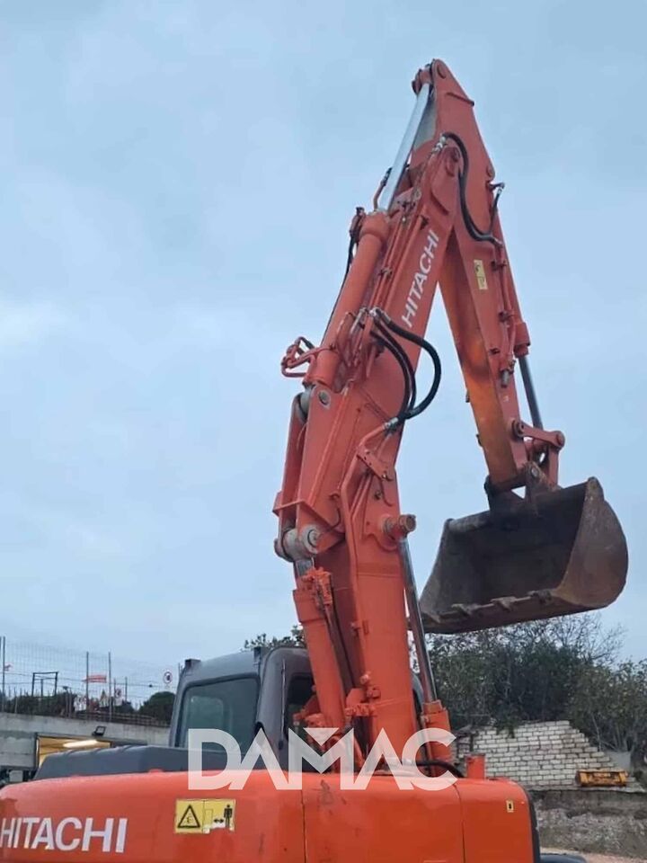 2006 Hitachi ZX130 crawler excavator, side view of boom and bucket 2006 Hitachi ZX130 crawler excavator, side view of boom and bucket