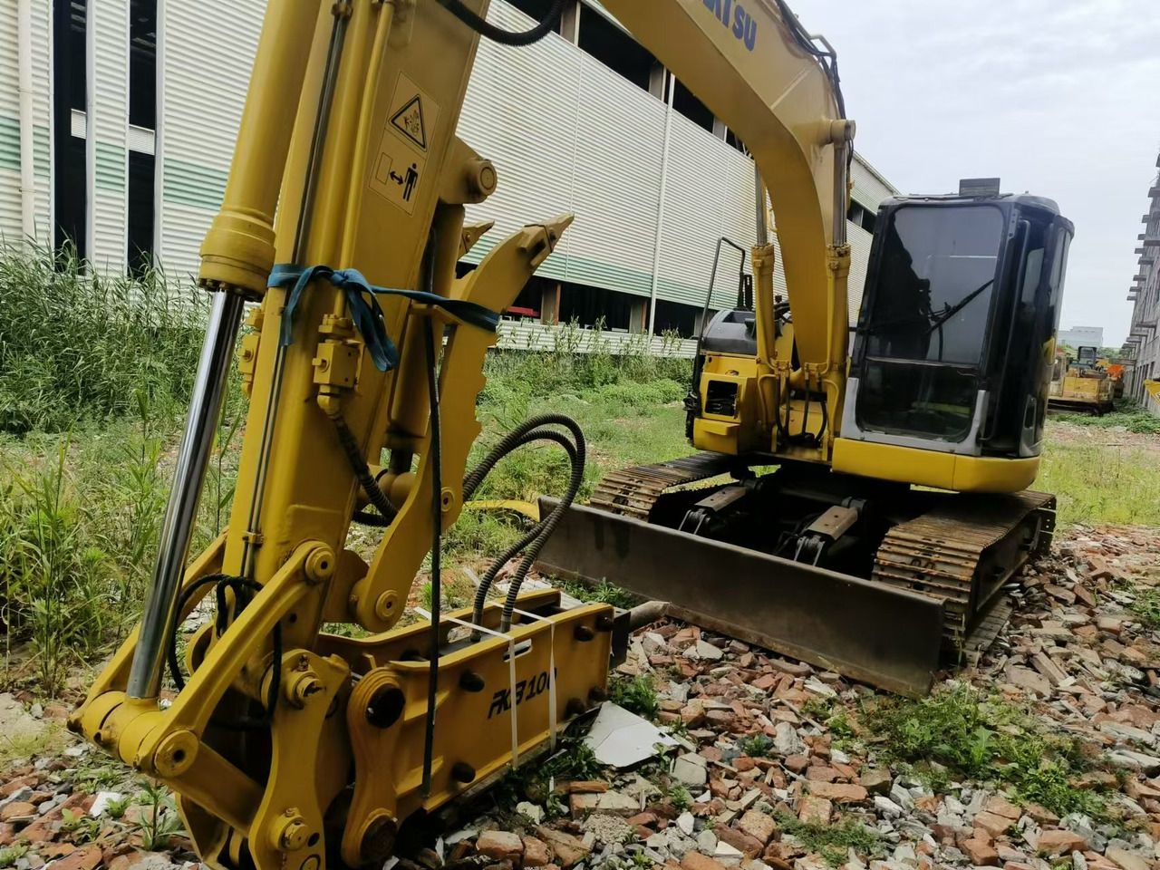 Komatsu PC128US excavator with hydraulic breaker attachment Komatsu PC128US excavator with hydraulic breaker attachment