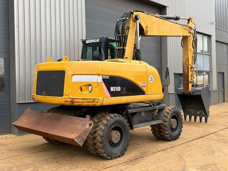 2008 Caterpillar M315D wheel excavator, rear three-quarter view 2008 Caterpillar M315D wheel excavator, rear three-quarter view