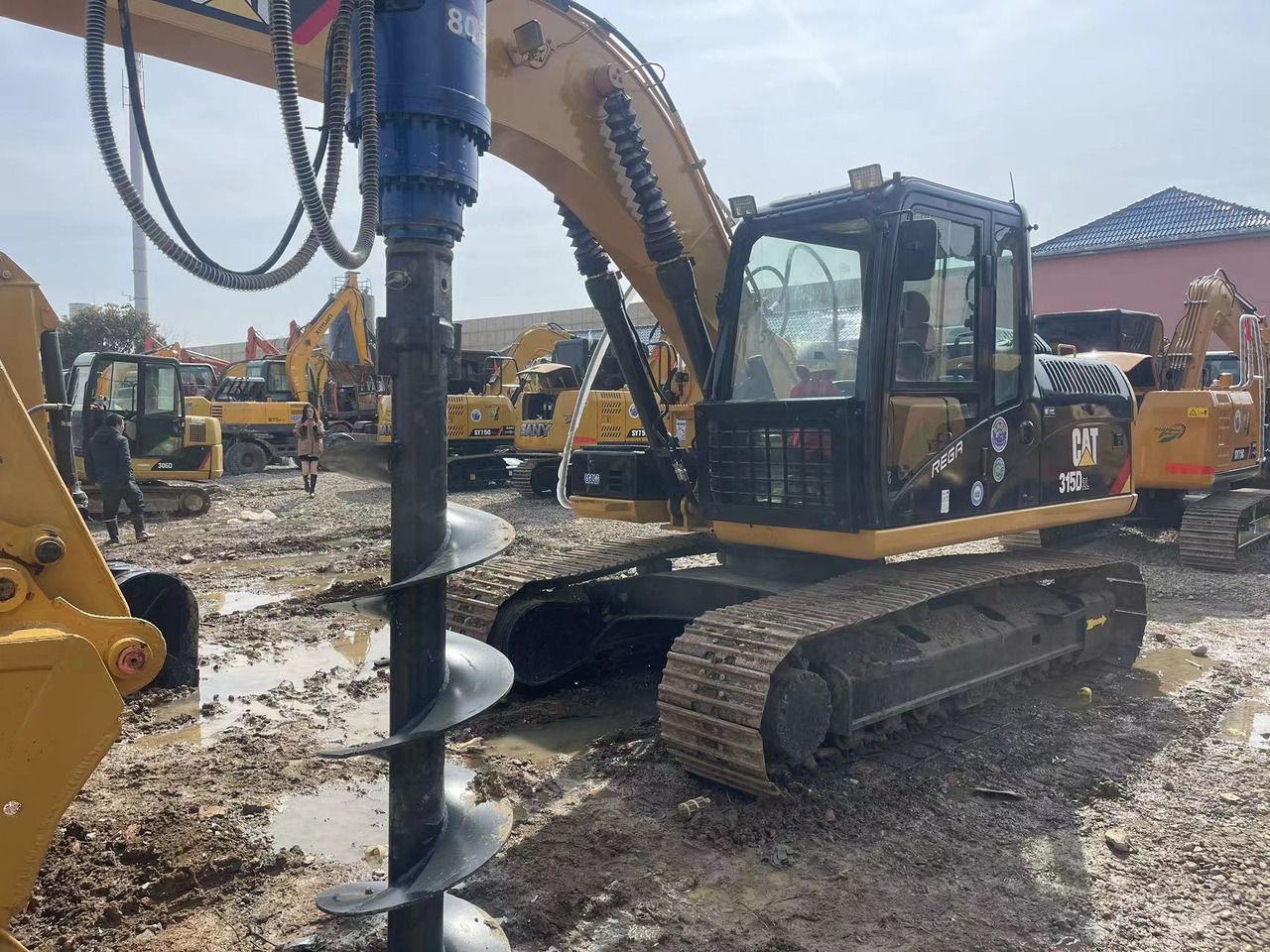 2024 Caterpillar 315D2L crawler excavator with auger attachment, side view 2024 Caterpillar 315D2L crawler excavator with auger attachment, side view