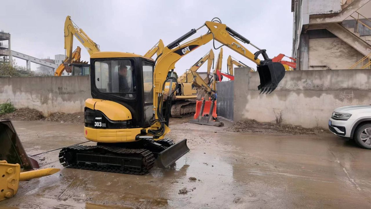 Caterpillar 303CR mini excavator, rear three-quarter view