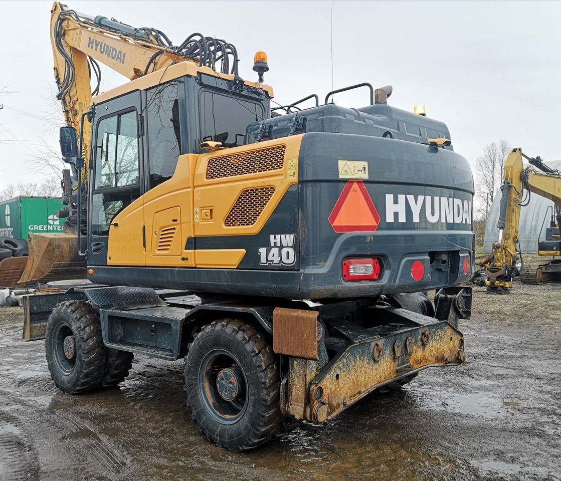 2016 Hyundai HW140 wheel excavator rear three-quarter view