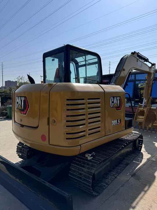 2023 Caterpillar 305.5 mini excavator, rear three-quarter view