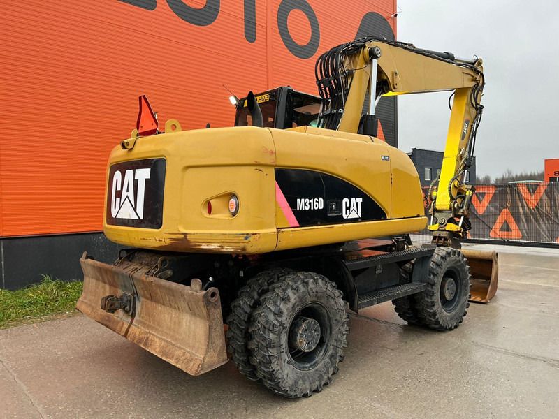 2011 Caterpillar M316D wheel excavator, rear three-quarter view 2011 Caterpillar M316D wheel excavator, rear three-quarter view