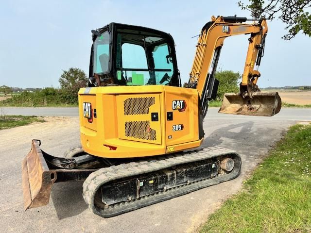 2024 Caterpillar 305 mini excavator, rear three-quarter view 2024 Caterpillar 305 mini excavator, rear three-quarter view