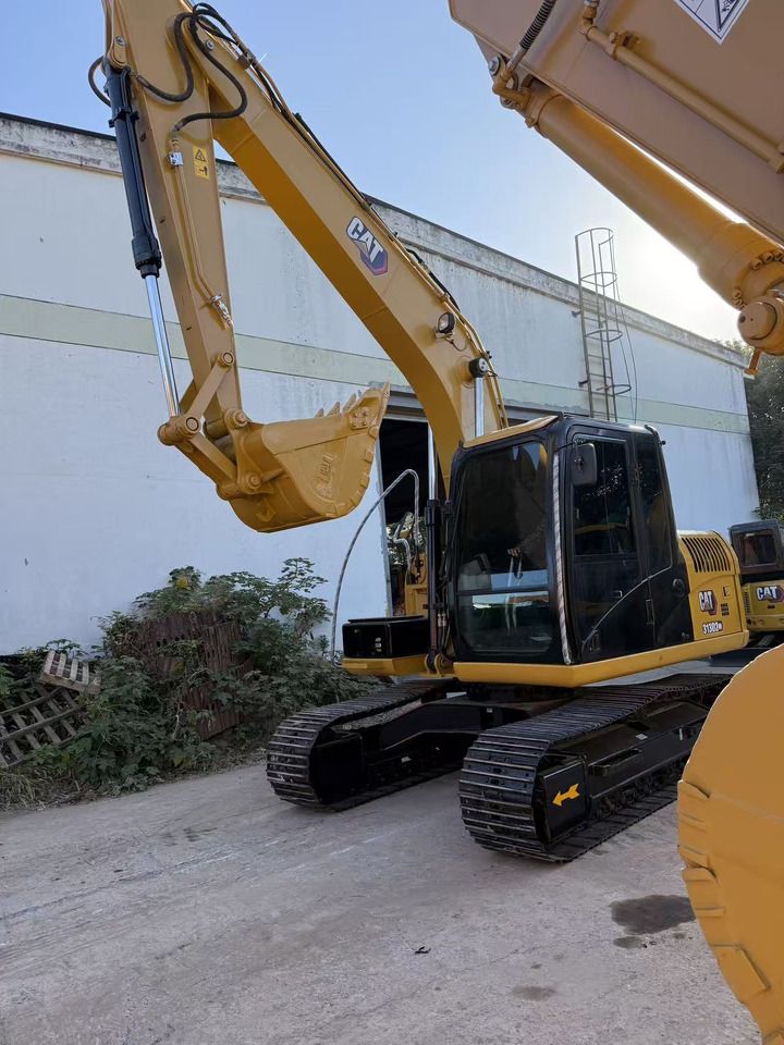 2021 Caterpillar 313D2 GC crawler excavator, front three-quarter view 2021 Caterpillar 313D2 GC crawler excavator, front three-quarter view
