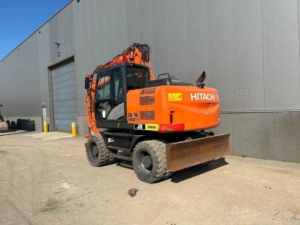 2015 Hitachi Zaxis 140W wheel excavator, rear three-quarter view 2015 Hitachi Zaxis 140W wheel excavator, rear three-quarter view