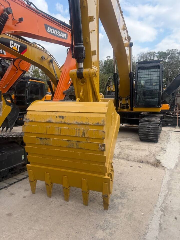 2024 Caterpillar 323 crawler excavator front view with bucket
