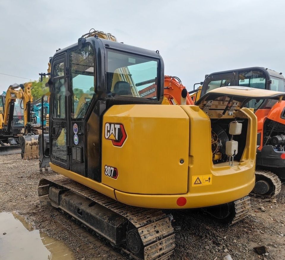 Caterpillar 307E mini excavator, rear three-quarter view Caterpillar 307E mini excavator, rear three-quarter view