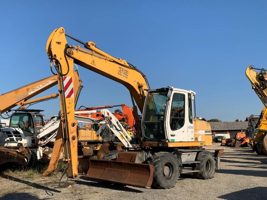 2002 Liebherr A312 wheel excavator, front three-quarter view 2002 Liebherr A312 wheel excavator, front three-quarter view
