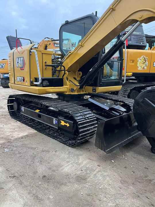 2024 Caterpillar 307E2 excavator, rear three-quarter view