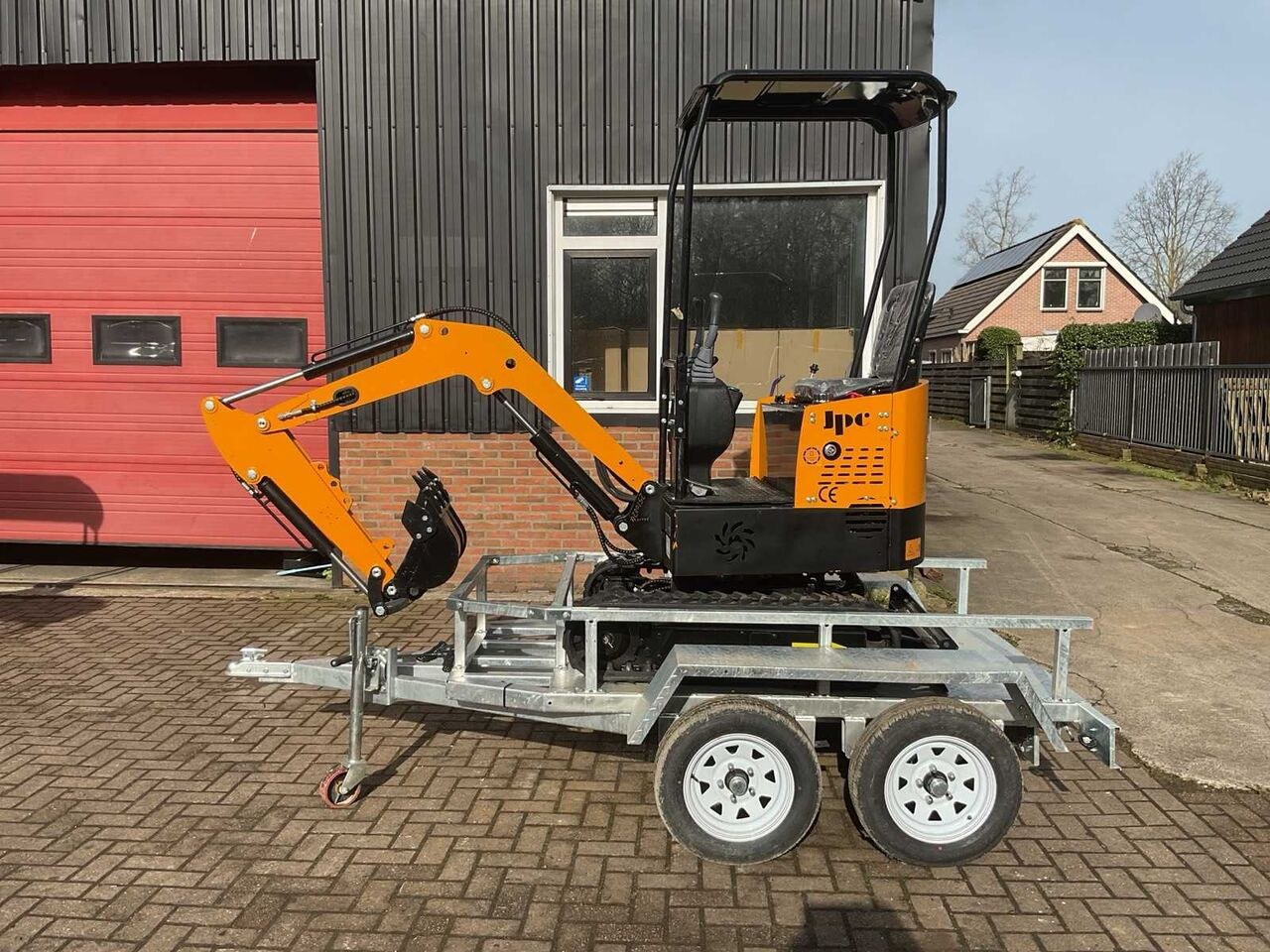 JPC HT-12 mini excavator on trailer, side view JPC HT-12 mini excavator on trailer, side view