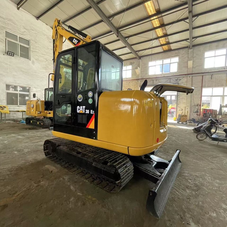 2023 Caterpillar 306E2 mini excavator, rear three-quarter view 2023 Caterpillar 306E2 mini excavator, rear three-quarter view
