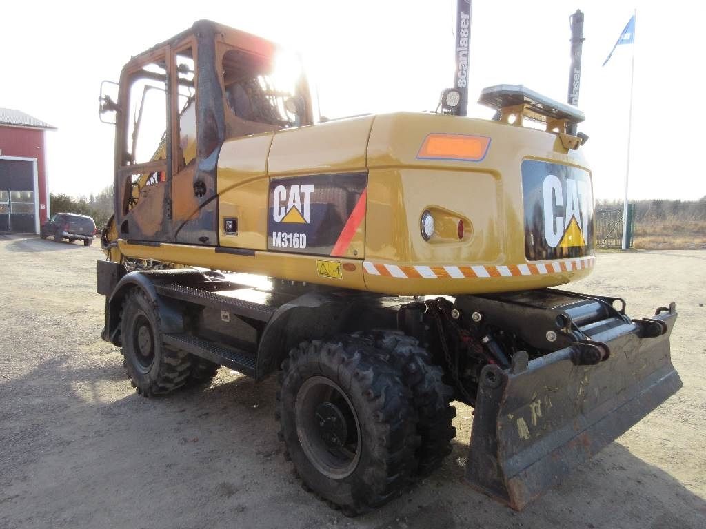 Caterpillar M316D wheel excavator, rear three-quarter view