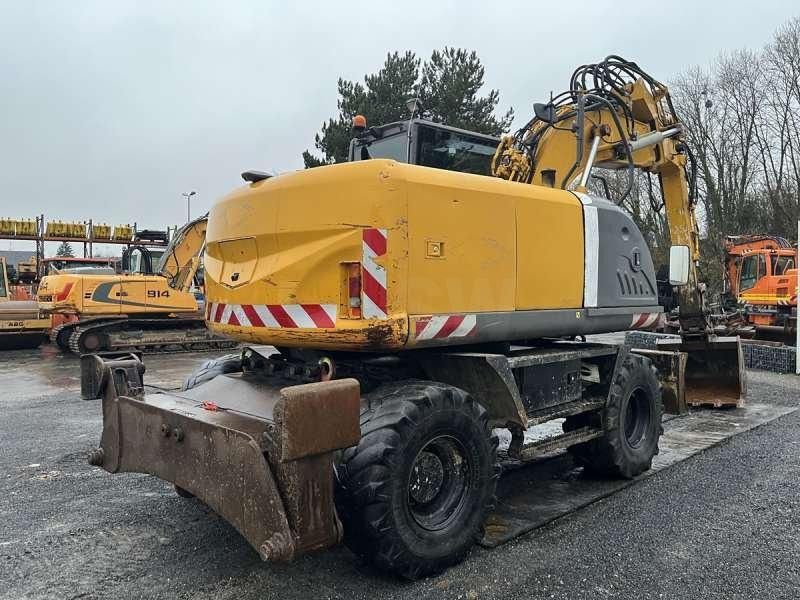 2010 Hitachi ZX140W-3 wheel excavator, rear three-quarter view 2010 Hitachi ZX140W-3 wheel excavator, rear three-quarter view