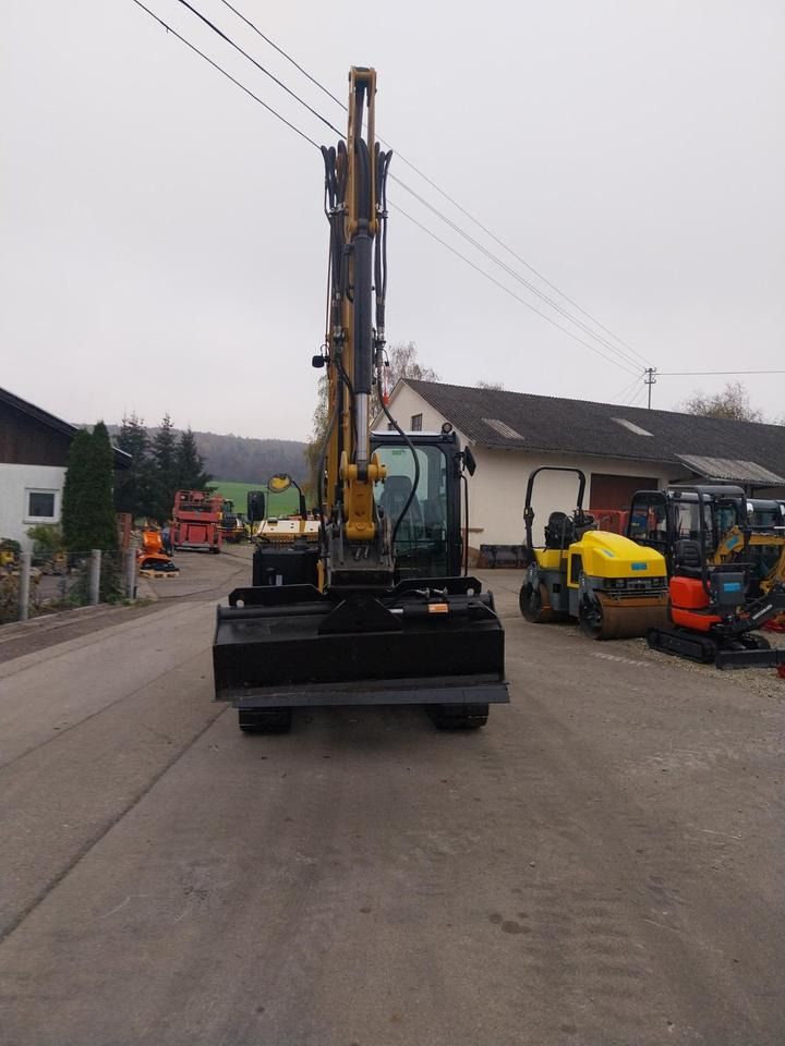 Caterpillar 306CR-07A mini excavator, front view with boom raised Caterpillar 306CR-07A mini excavator, front view with boom raised