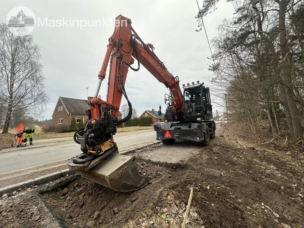 2018 Hitachi ZX140W-6 wheel excavator, rear three-quarter view 2018 Hitachi ZX140W-6 wheel excavator, rear three-quarter view