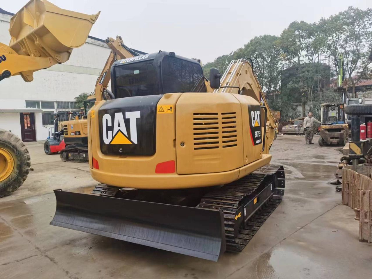 2018 Caterpillar 307E2 mini excavator, rear three-quarter view 2018 Caterpillar 307E2 mini excavator, rear three-quarter view