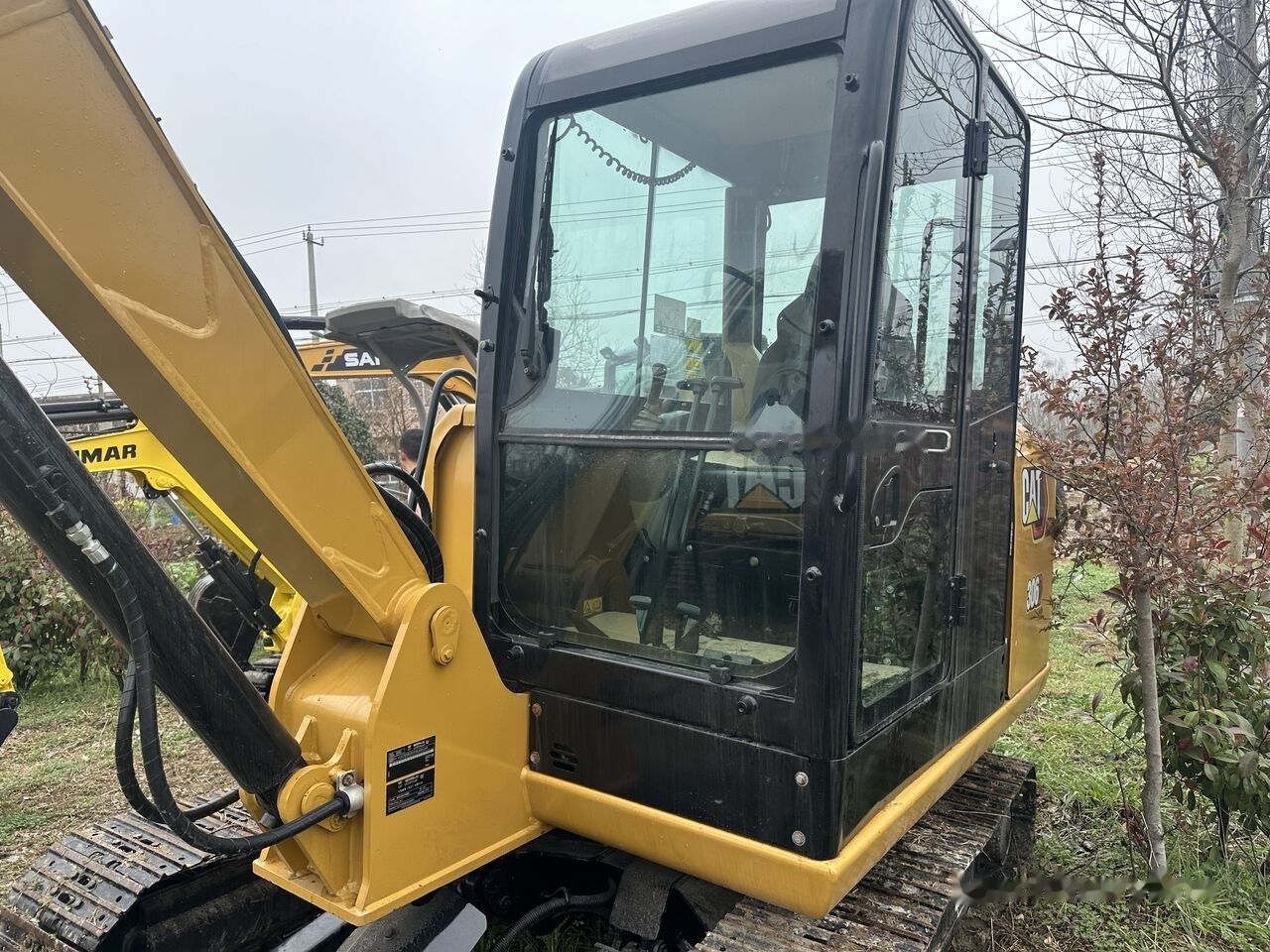 Caterpillar 306 mini excavator, side view of cab and boom