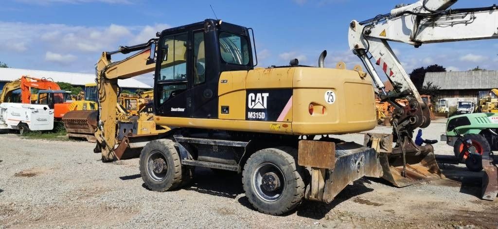 2011 Caterpillar M315D wheel excavator, rear three-quarter view