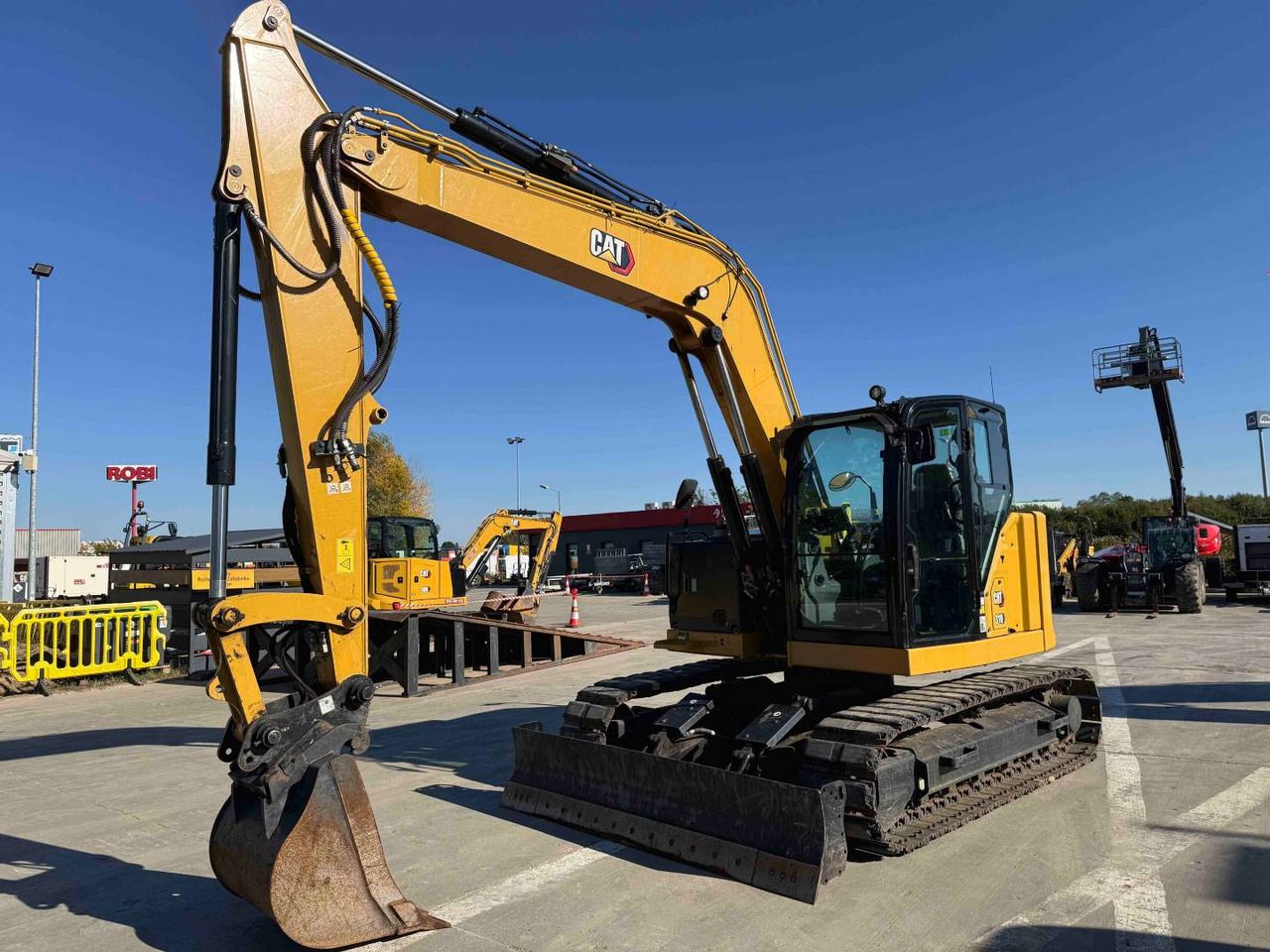 2022 Caterpillar 310 crawler excavator, side view